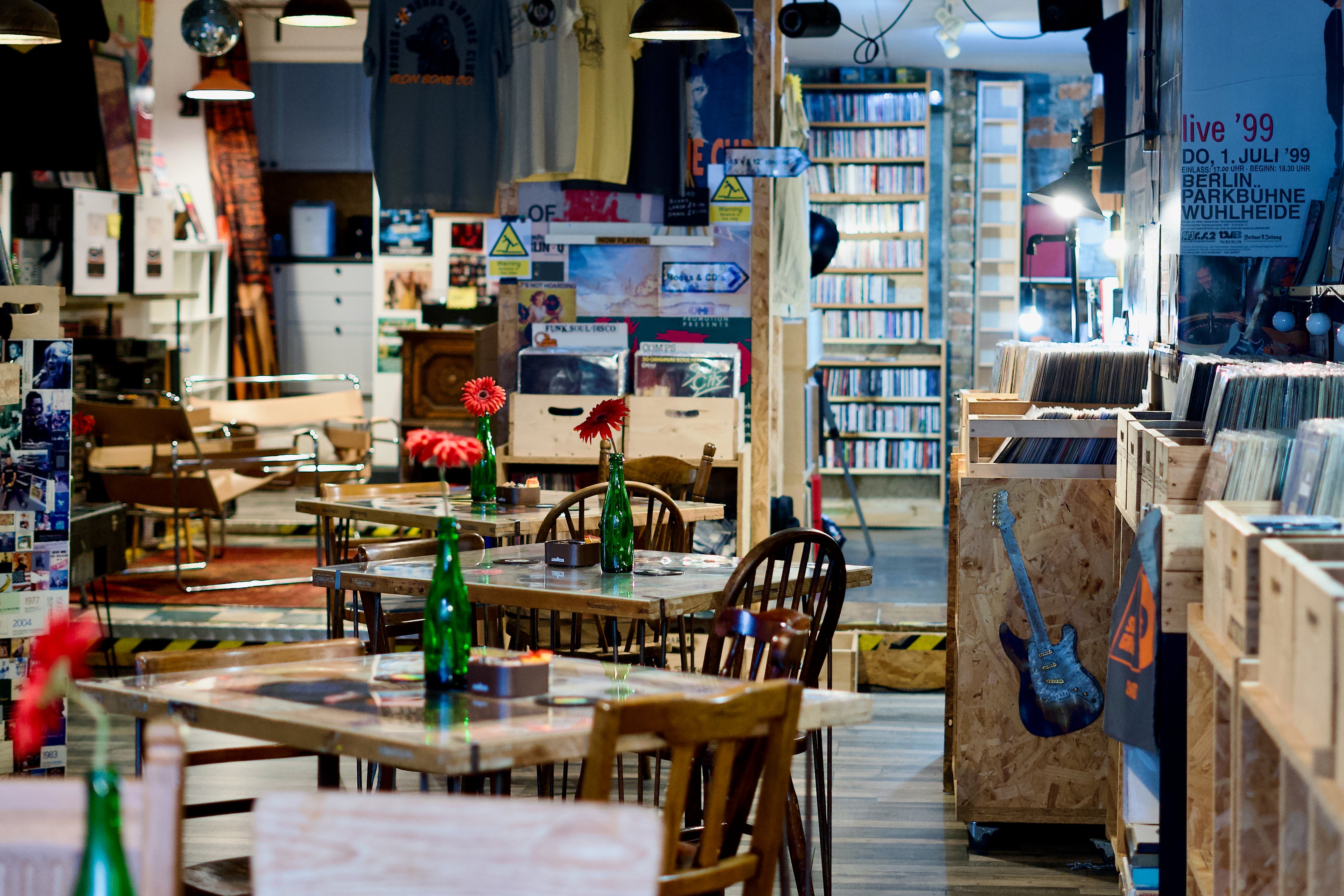 Interior of a Sounds and grounds record shop with tables, chairs, and record albums.