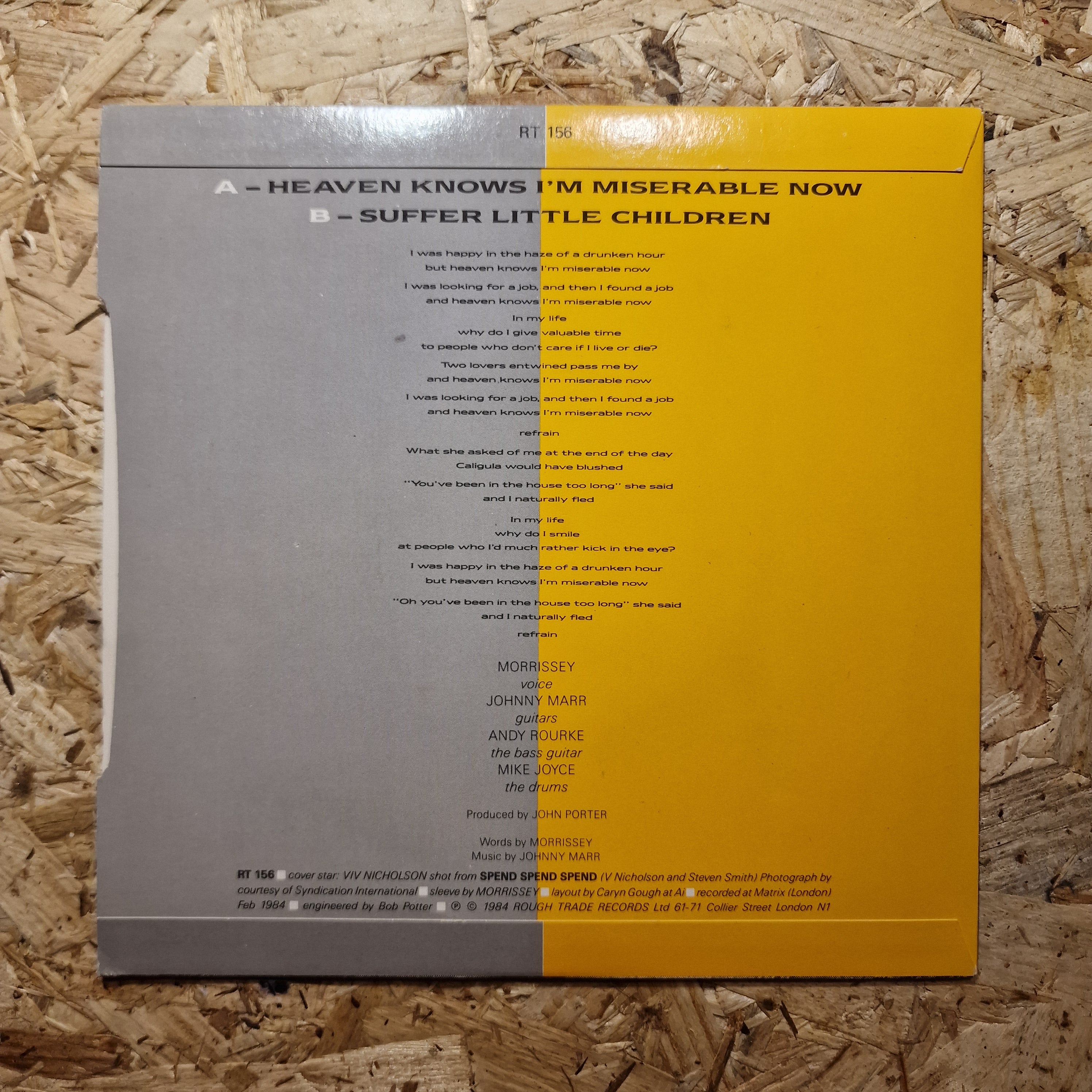 Back cover with yellow and grey design on a wooden surface