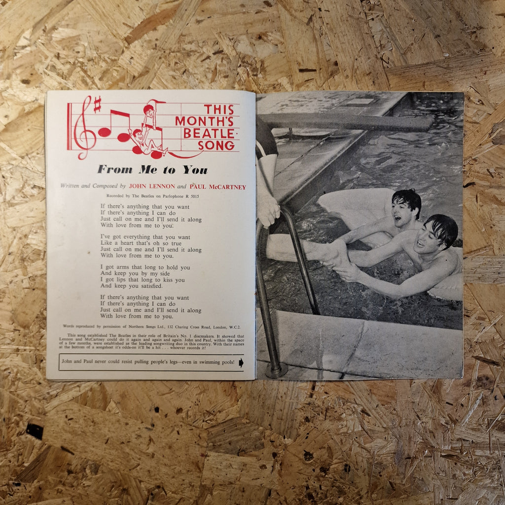 Sheet music for 'From Me to You' by The Beatles on a wooden surface with a black and white photo of two people.