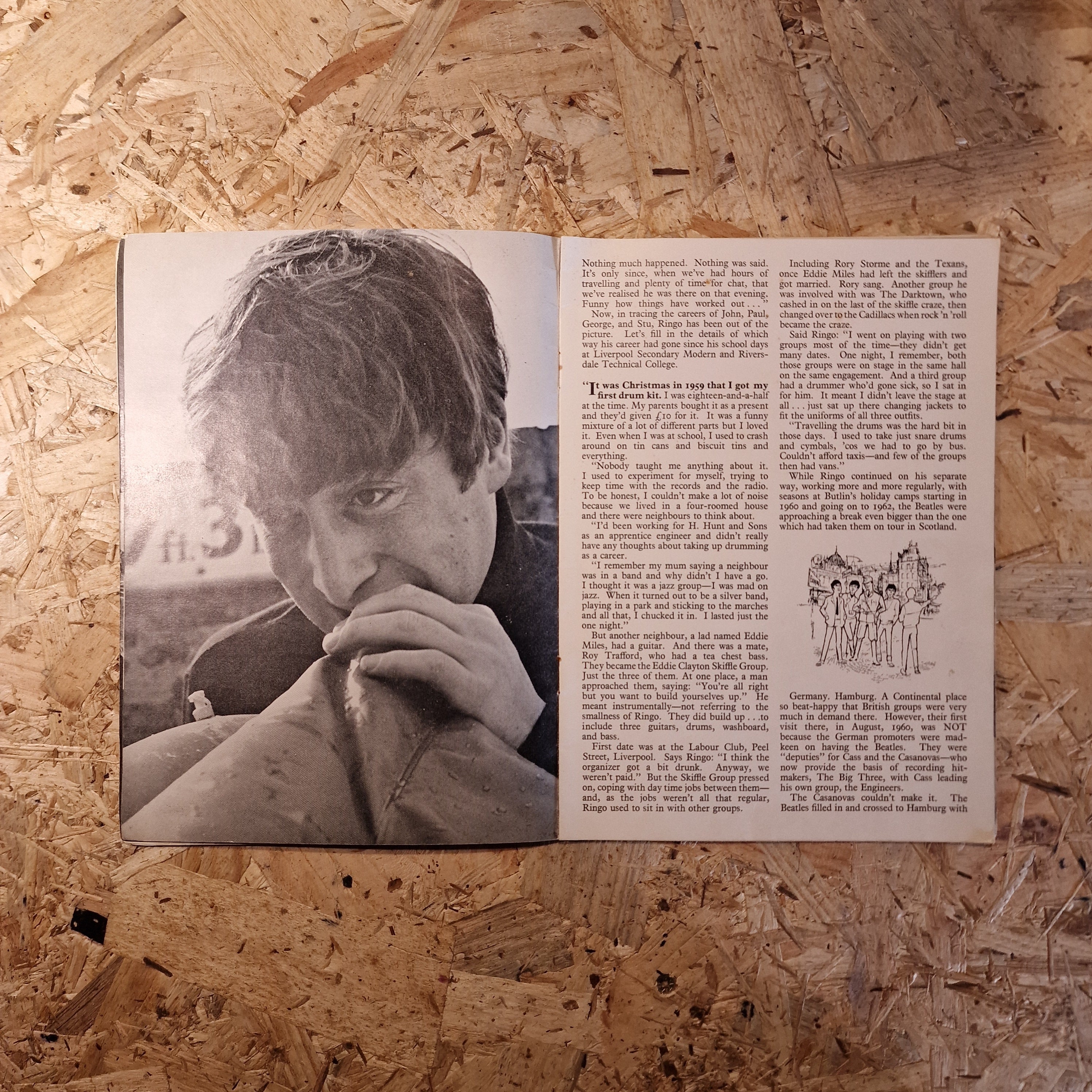 Open book with a black and white photo and text on a wooden surface