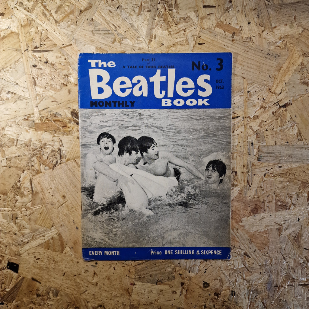 Vintage 'The Beatles Monthly' book on a wooden surface