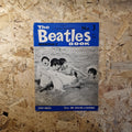 Vintage 'The Beatles Monthly' book on a wooden surface