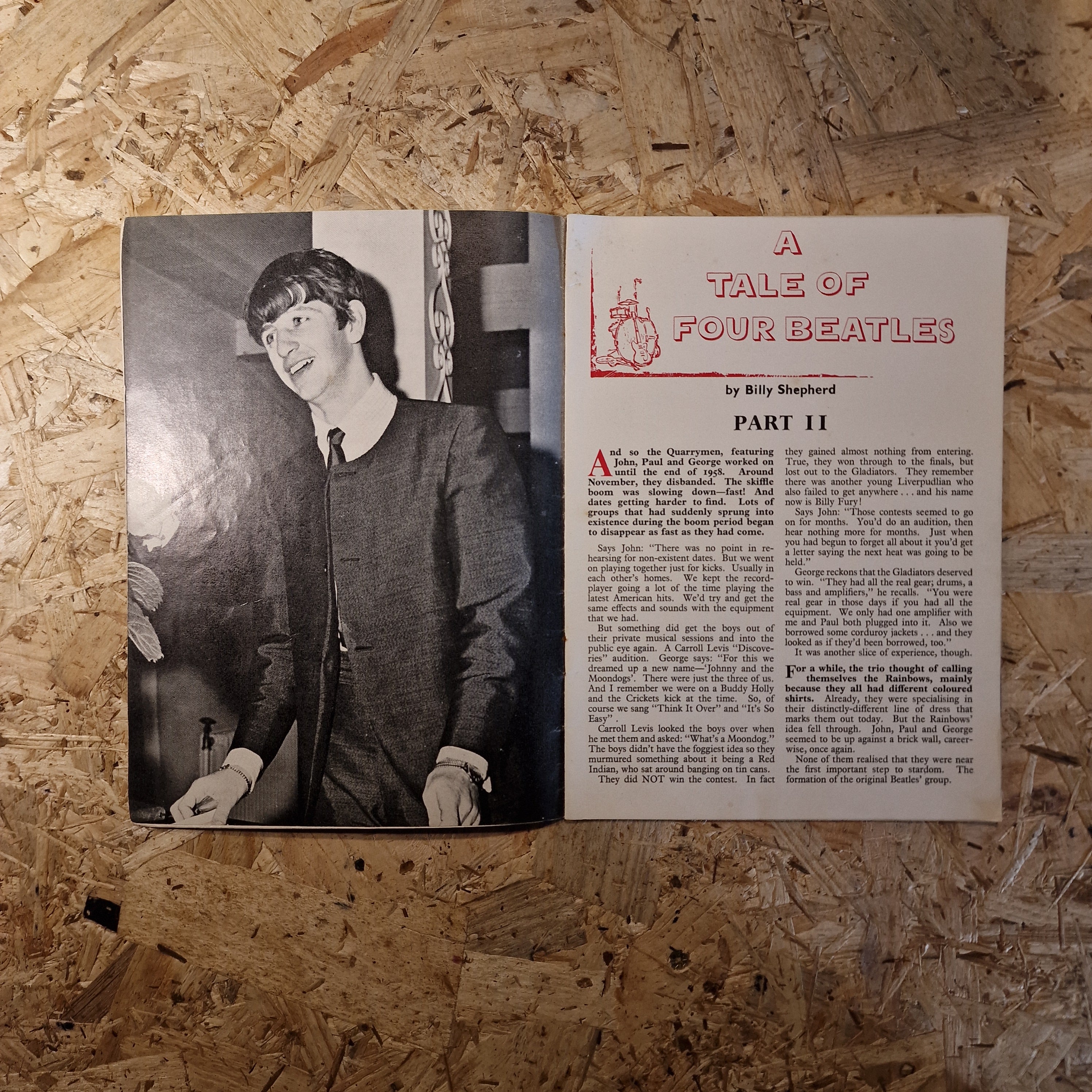 Book or magazine with text and a black and white photo on a wooden surface
